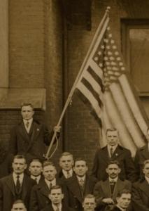 Man in a group holding an American flag